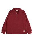 A long-sleeve polo shirt in a heathered burgundy red, featuring a two-button placket and a small brand label on the lower right hem, displayed flat against a light gray background.
