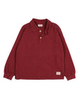 A long-sleeve polo shirt in a heathered burgundy red fabric, featuring a two-button placket and a small rectangular brand patch near the lower hem, displayed flat against a light gray background.