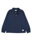 A navy blue long-sleeve polo shirt with a two-button placket and a small brand patch on the lower left hem, displayed flat against a light gray background.