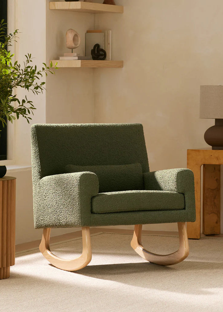 Green armchair in a room with wooden tables and decor