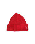 A bright red ribbed knit beanie hat with a small white embroidered lowercase 'b' logo on the folded cuff, shown against a plain light gray background.