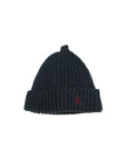 A dark navy blue ribbed knit beanie hat with a small red embroidered logo on the front cuff, shown against a plain light gray background.