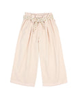 A pair of light pink wide-leg trousers for kids, featuring an elastic waistband with a small floral pattern and a matching fabric bow at the front.