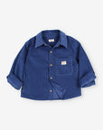 A blue corduroy button-up shirt with rolled-up sleeves and a chest pocket, laid flat on a light gray background.