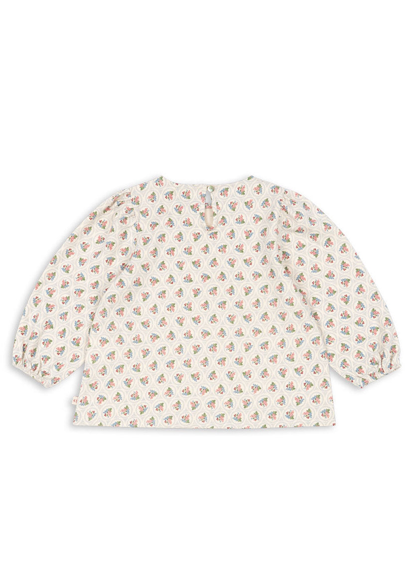 Baby blouse with floral pattern on a white background