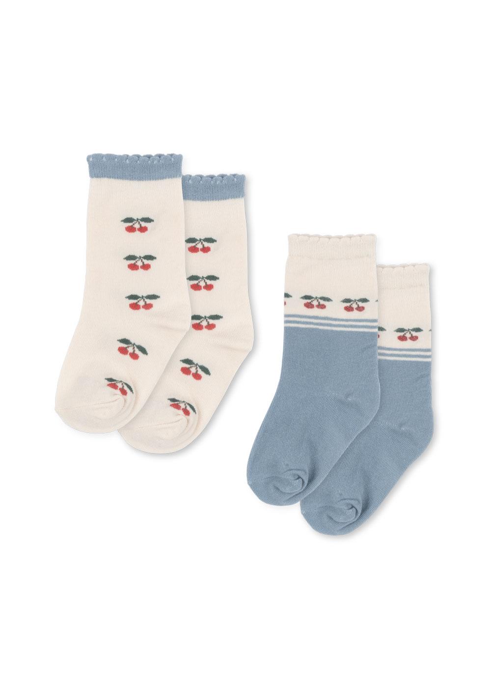 Two pairs of socks with cherry design on a white background