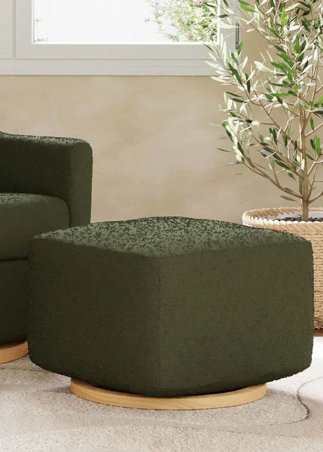 Green upholstered armchair and ottoman in a room with a plant and window.