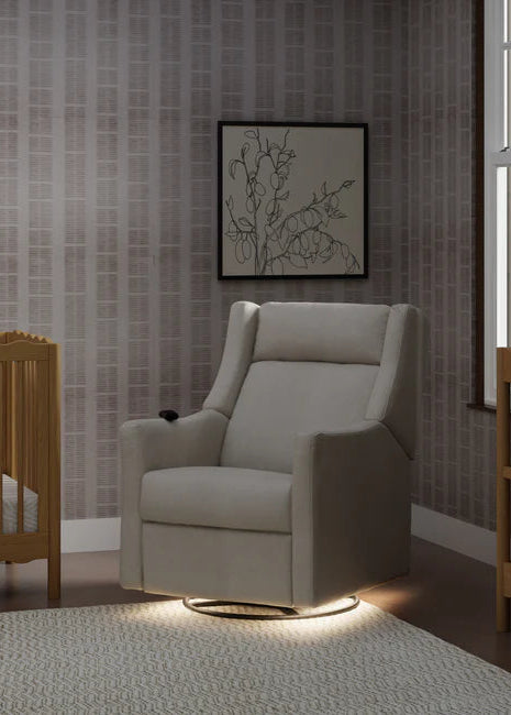 Nursery room with a gray armchair, crib, and changing table.